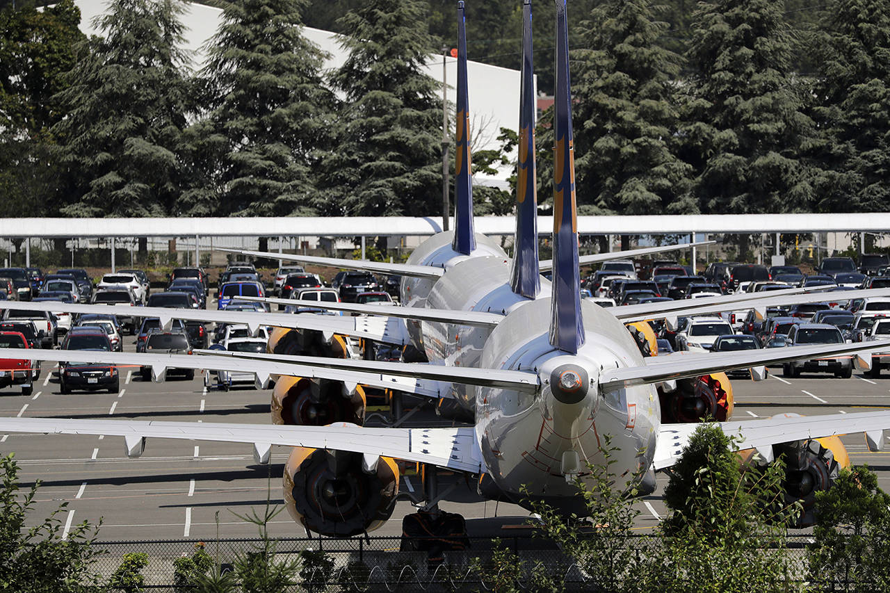 In this Aug. 15 photo, three grounded Boeing 737 Max airplanes, built for Icelandair, sit parked in a lot normally used for cars in an area adjacent to Boeing Field, in Seattle. (AP Photo/Elaine Thompson, File)