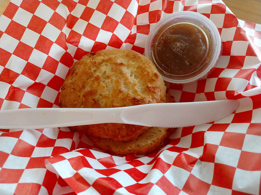 Order buttermilk or cheddar onion biscuits with your choice of spread: raspberry, tomato or bacon jam, maple, honey, mocha or apple butter, herbed goat cheese or Mama’s Lil Pepper Aioli. (Sara Bruestle/The Herald)
