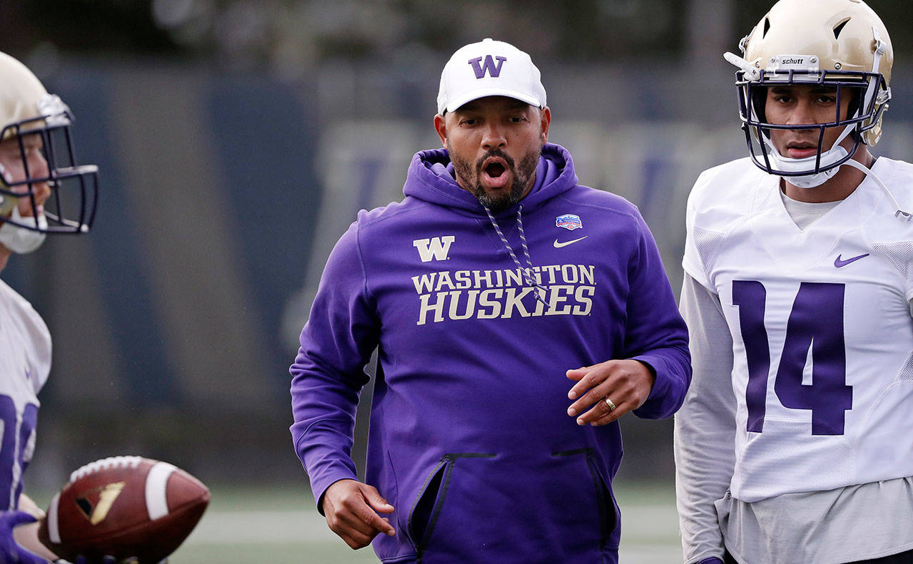 Jimmy Lake (center) was named Washington’s new head football coach after Chris Petersen announced he was stepping down. (AP Photo/Elaine Thompson)
