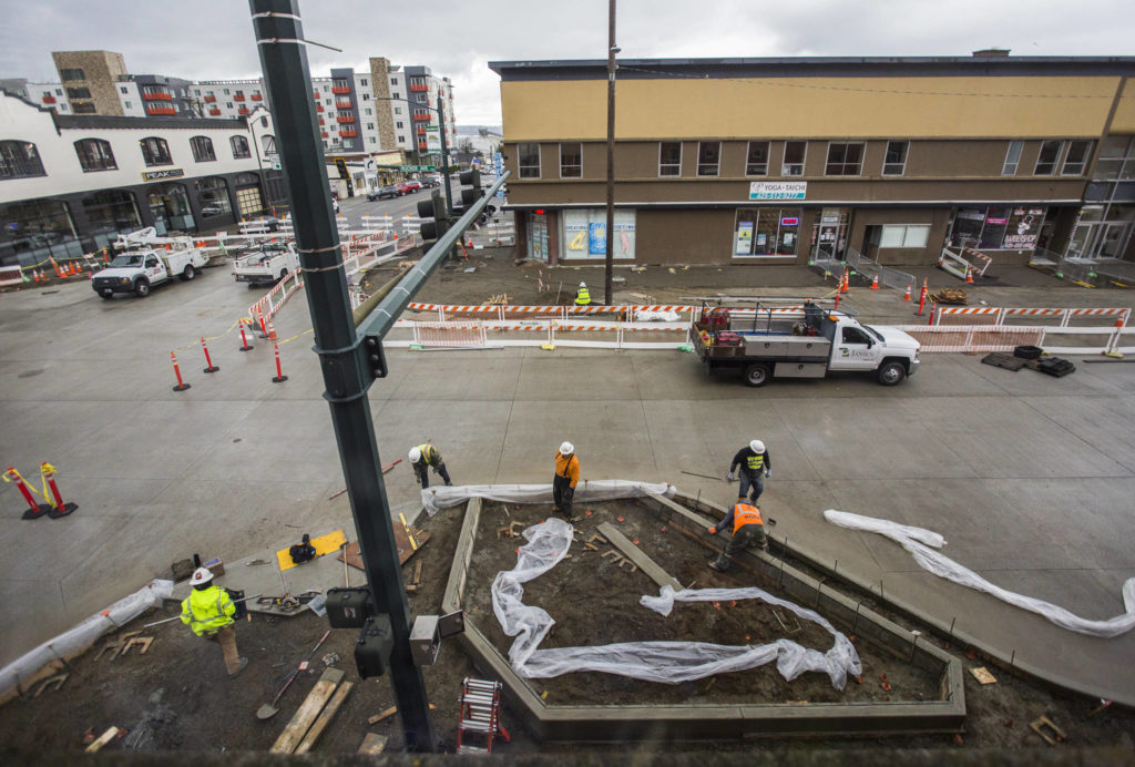 Construction workers rebuild the northeast corner of Hewitt and Rucker avenues on Thursday in Everett. (Olivia Vanni / The Herald)
