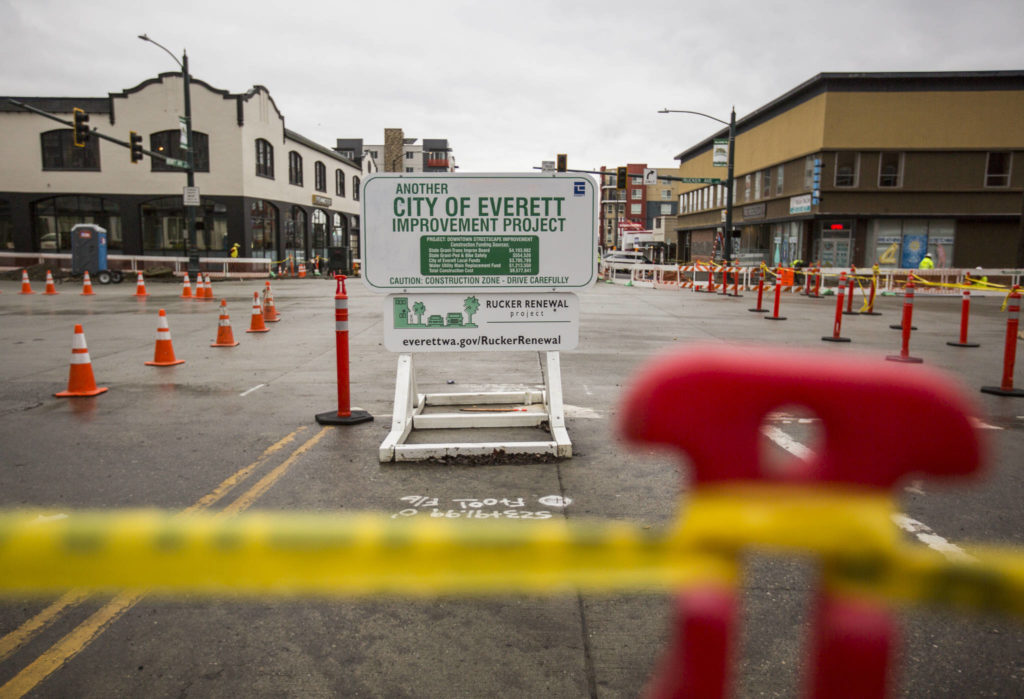 Traffic cones and yellow caution tape help guide pedestrians about where they’re able to walk during construction. (Olivia Vanni / The Herald)
