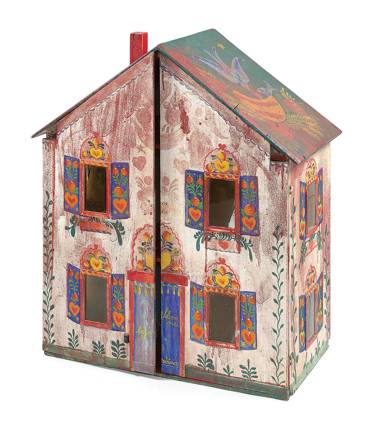 The folk art paintings on the dollhouse are the signed work of Peter Hunt. The 39-inch-high plywood toy was decorated in 1941. (Cowles Syndicate Inc.)