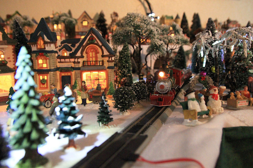 Tammy Butler, of Oak Harbor, sets up an ever-expanding Christmas village in her living room each December. She added a skating rink, lighthouse, toy store and hunters’ lodge this year. (Laura Guido/Whidbey News-Times)
