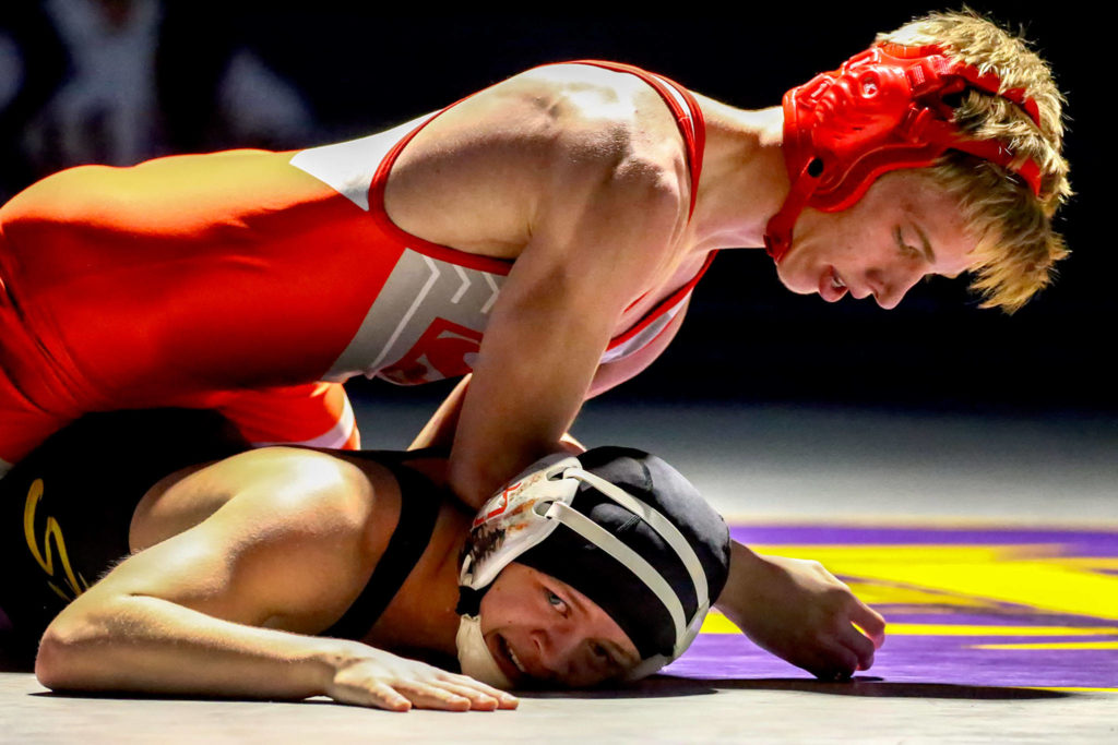 Stanwood’s Keaton Mayernik (top) works to pin Lake Stevens’ Aiden Eberlein Thursday evening at Lake Stevens High School on December 12, 2019. Lake Stevens won 49-24. (Kevin Clark / The Herald)
