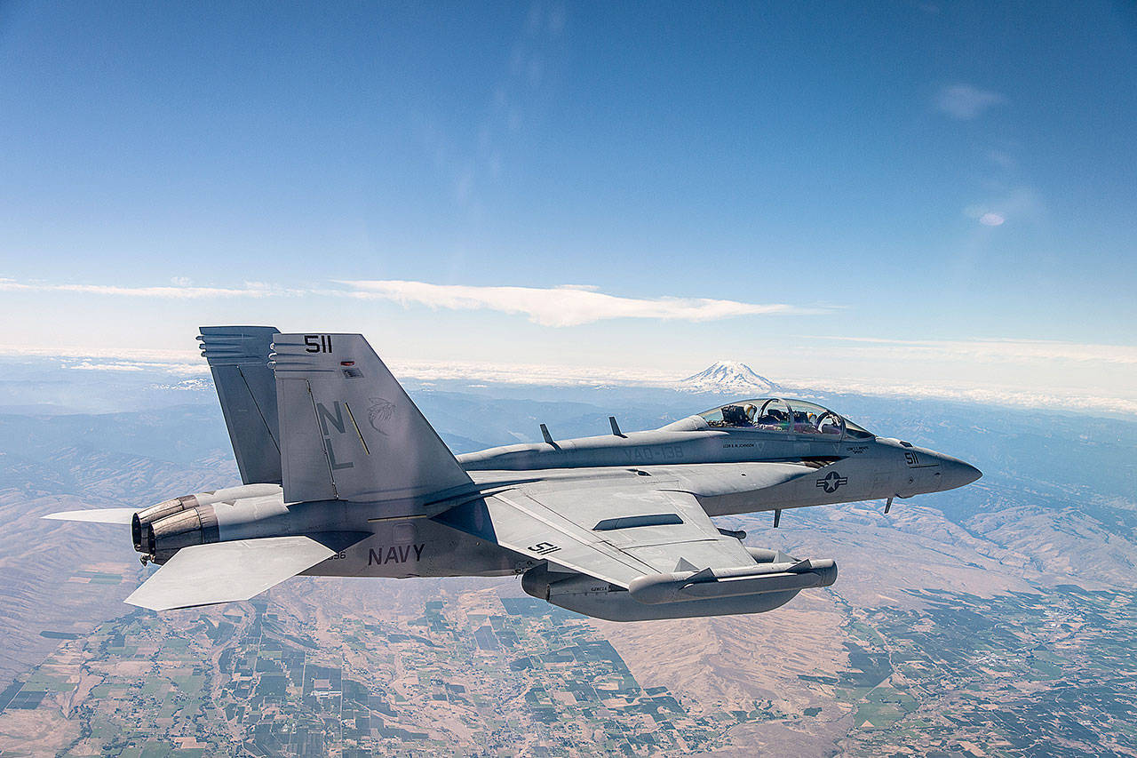 An EA-18G Growler with VAQ-138 from NAS Whidbey Island flies above Washington State.(U.S. Navy)