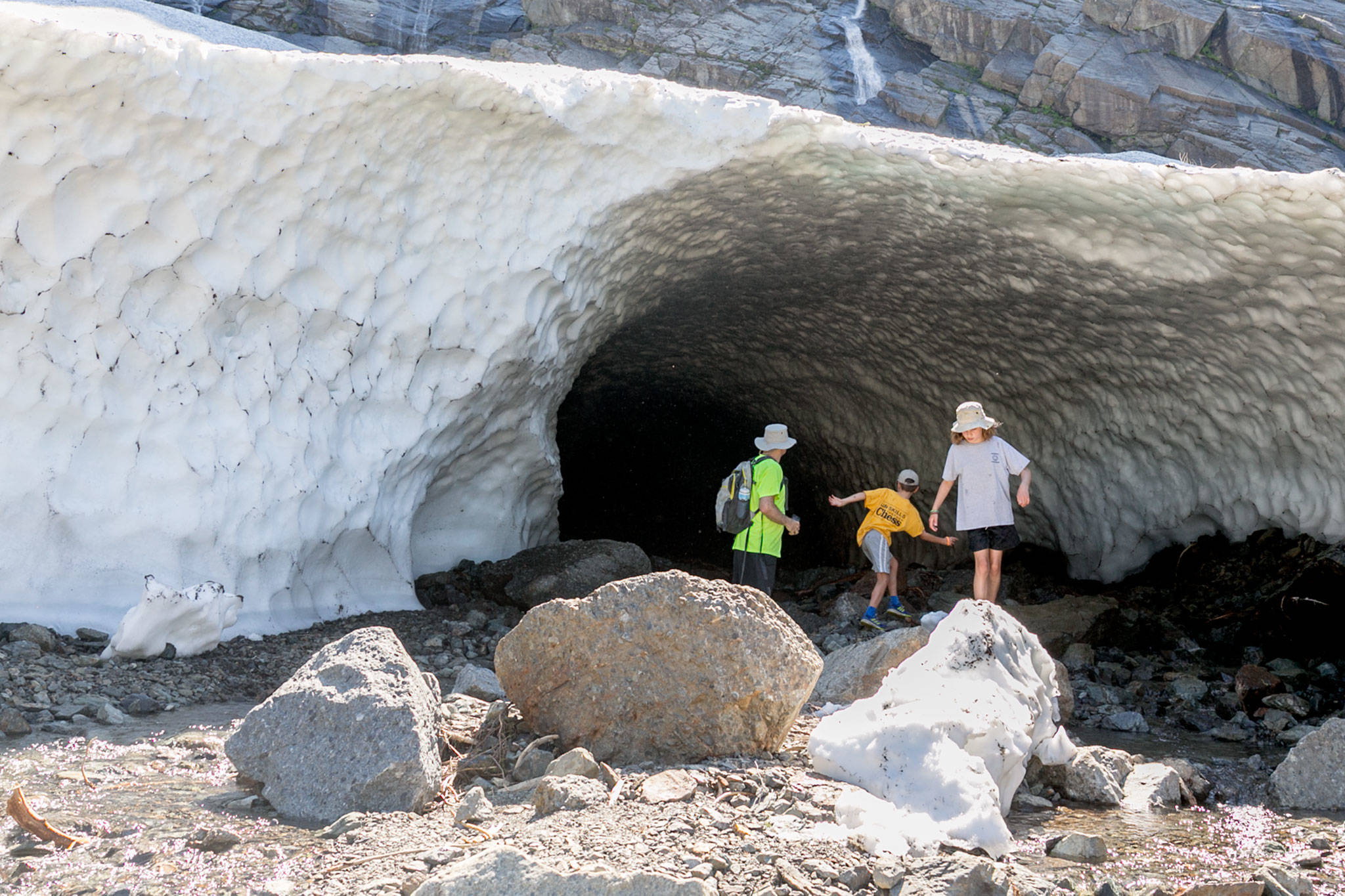 Hikers take in the sites of the Big Four Ice Caves in Granite Falls on July 12, 2018. (Kevin Clark / Herald file)