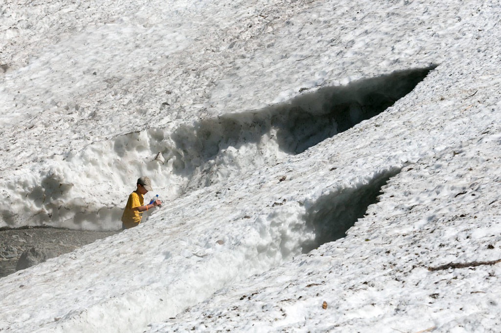 Hikers take in the sights of the Big Four Ice Caves in Granite Falls on July 12, 2018. (Kevin Clark / Herald file)
