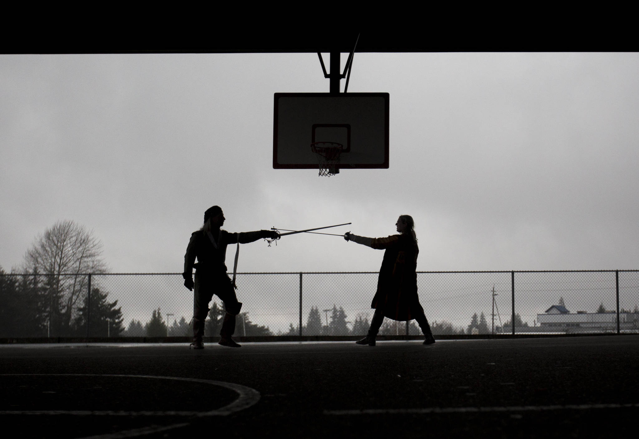 Stephen Henning (left), whose LARP persona is Conal McLaren, works on fencing techniques with Bethaney Dukellis, whose persona, Halawa Al-Waddi, is Concal McLaren’s cadet, during practice at Evergreen Middle School in Everett. (Olivia Vanni / The Herald)