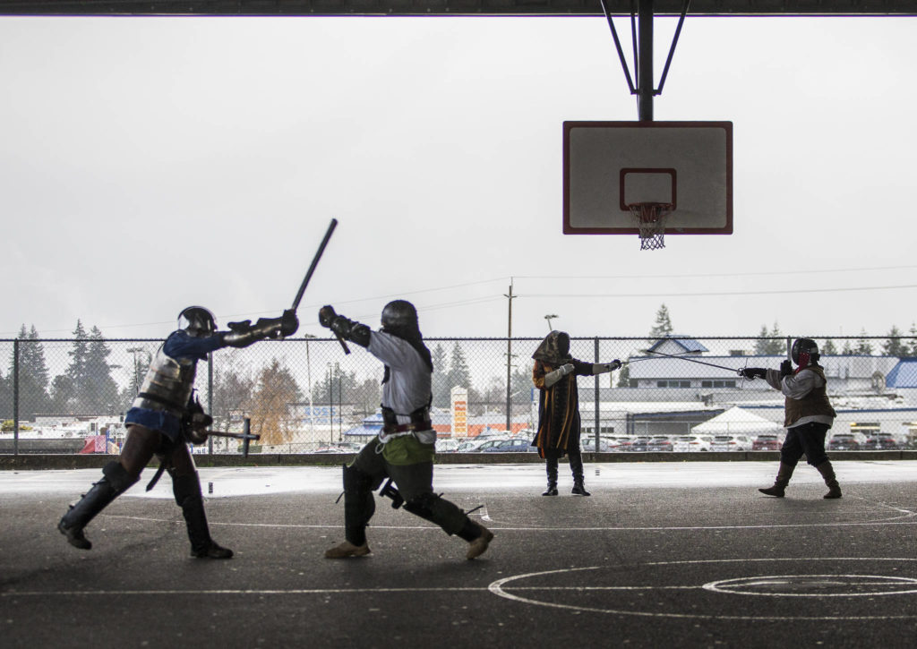 Members of the Barony of Aquaterra practice at Evergreen Middle School in Everett. The Barony is the Snohomish County chapter of the Society for Creative Anachronism. (Olivia Vanni / The Herald)
