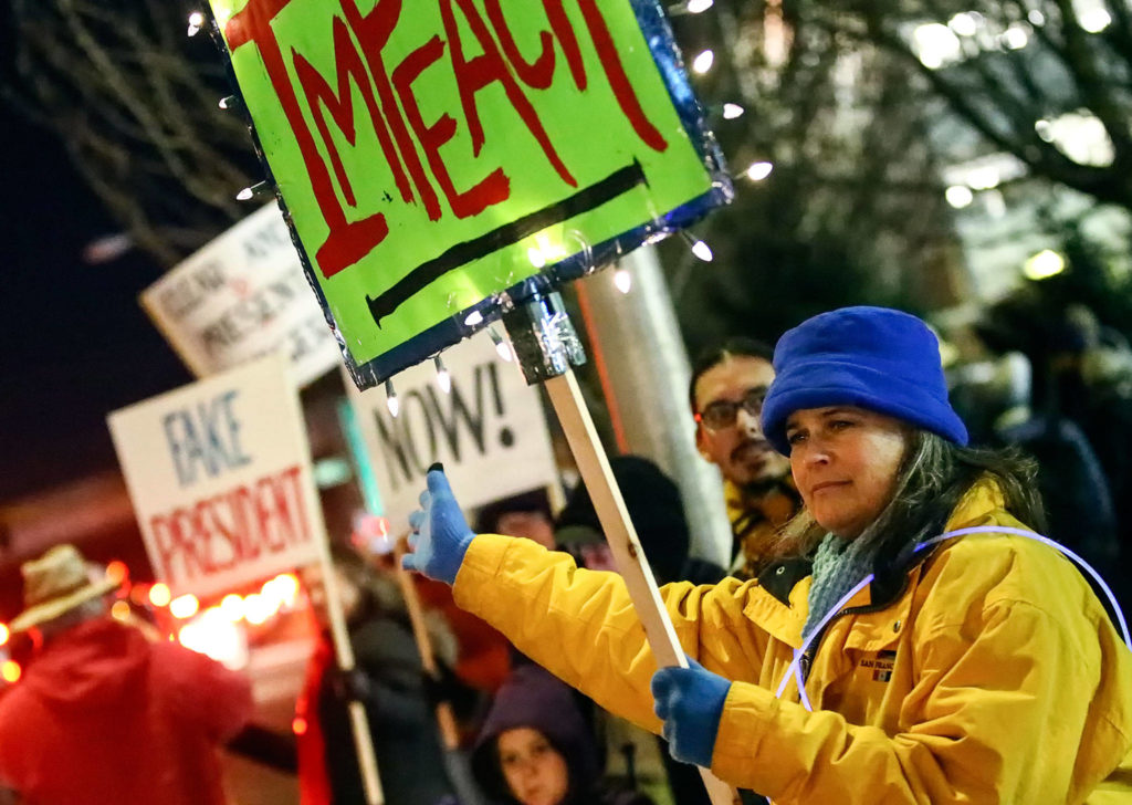 Hundreds gathered in support of the impeachment of President Donald Trump Tuesday evening along Broadway in Everett. (Kevin Clark / The Herald)
