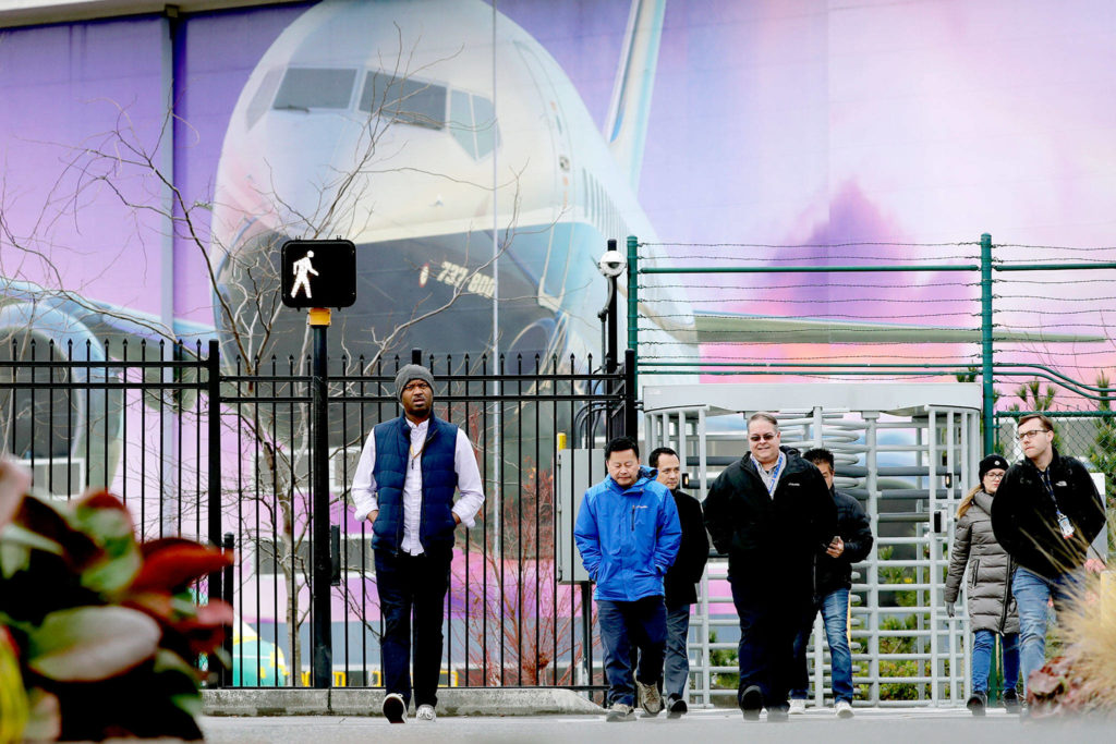 Boeing workers exit the company’s factory in Renton on Monday. (AP Photo/Elaine Thompson)
