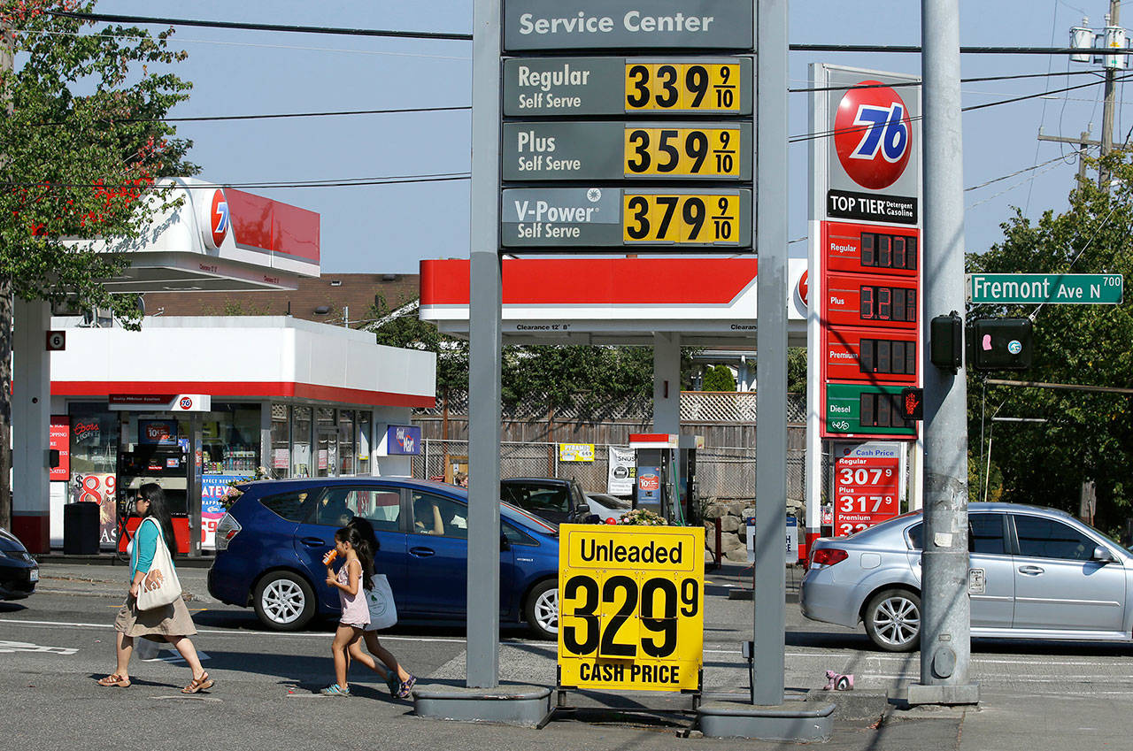 In this 2015 photo, cash and credit prices price for gasoline are shown at two gas stains in Seattle. (AP Photo/Ted S. Warren, file)