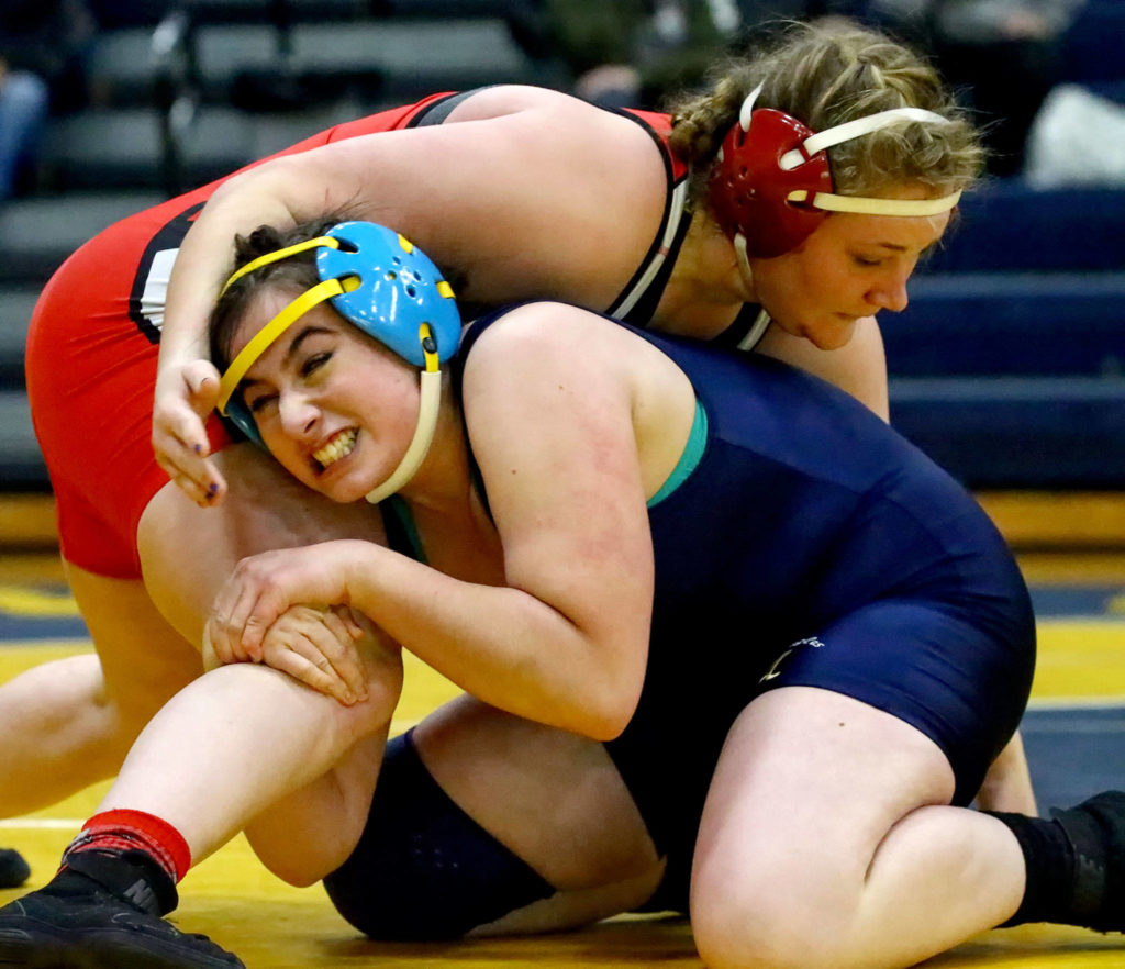 Snohomish’s Madi Marshall (top) wrestles and pin Arlington’s Souzanna Crew Wednesday evening at Arlington High School in Arlington on December 18, 2019. Arlington beat Snohomish/Glacier Peak 66-18. (Kevin Clark / The Herald)
