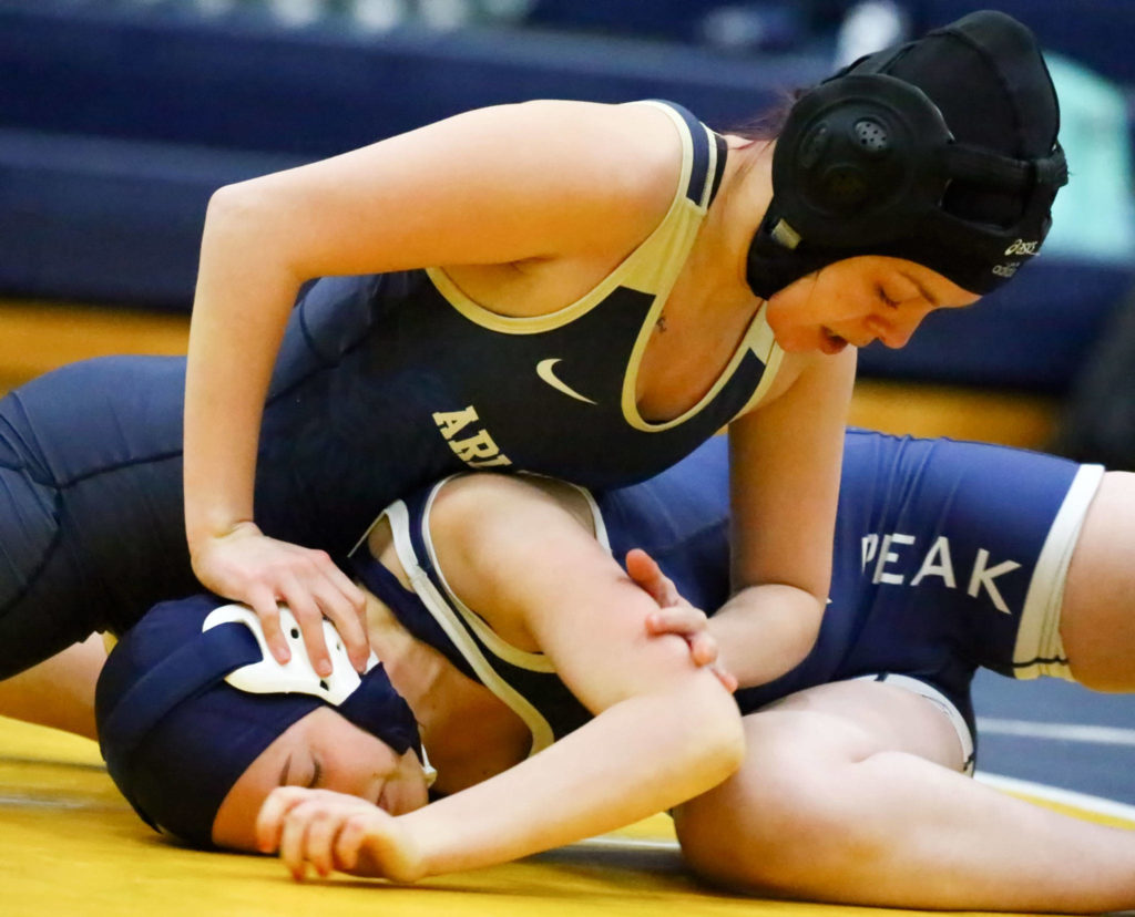 Arlington’s Ana Grwordske wrestles and pins Glacier Peak’s Lilly Germer Wednesday evening at Arlington High School in Arlington on December 18, 2019. Arlington won 66-18. (Kevin Clark / The Herald)
