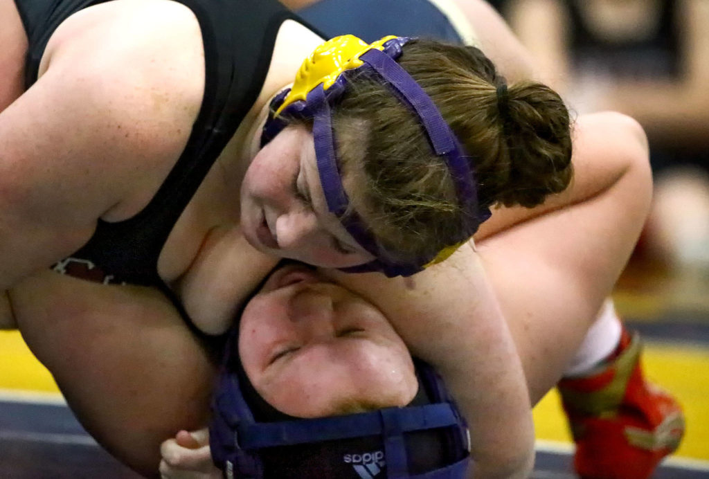 Marysville Pilchuck’s Alivia White wrestles and pins Arlington’s Brianna Williams-Bales Wednesday evening at Arlington High School in Arlington on December 18, 2019. Arlington won 60-18. (Kevin Clark / The Herald)
