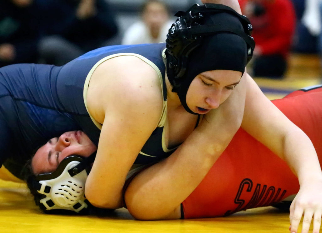 Arlington’s Raina Allen wrestles and pins Snohomish’s Hannah Wheeler Wednesday evening at Arlington High School in Arlington on December 18, 2019. Arlington won 66-18. (Kevin Clark / The Herald)
