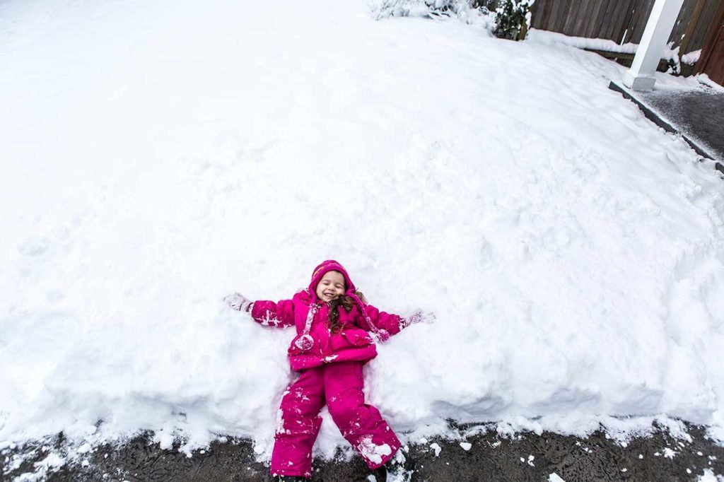Making a snow angel brings a joyful smile to the face of Kaylee Williams, 3. (Olivia Vanni/The Herald)
