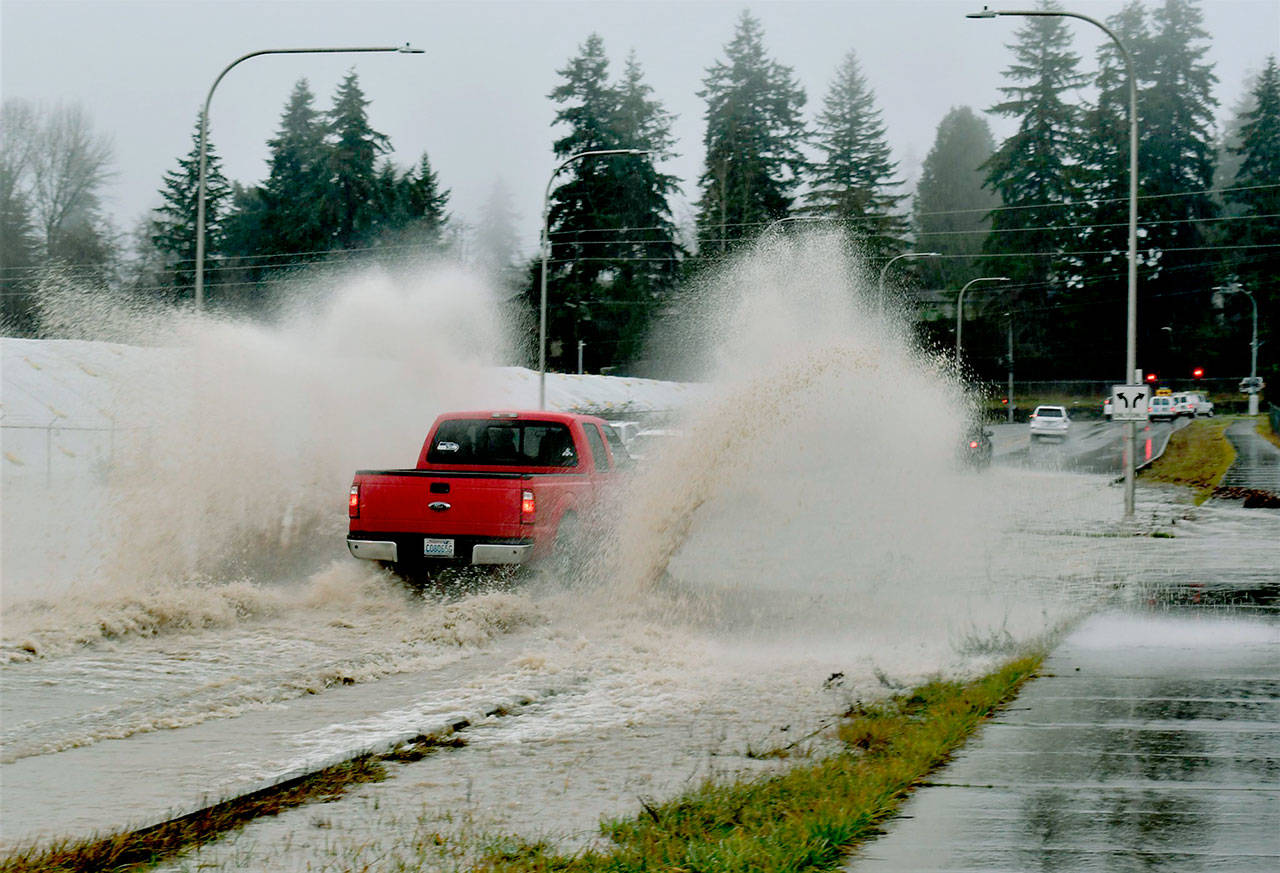 A truck plows through high water on a street in southwest Everett. (Snohomish County Department of Emergency Management)