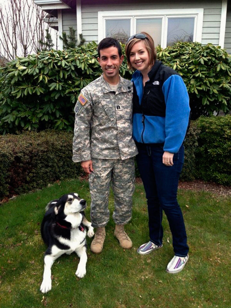 Nikki and Adam Abeyta, both Army majors, with LuLu, the dog Nikki befriended in Afghanistan. LuLu lives in Everett with Nikki Abeyta’s parents, Nick and Debbie Schmitz. The Abeytas are based at Fort Bragg in North Carolina. (Courtesy Debbie Schmitz)
