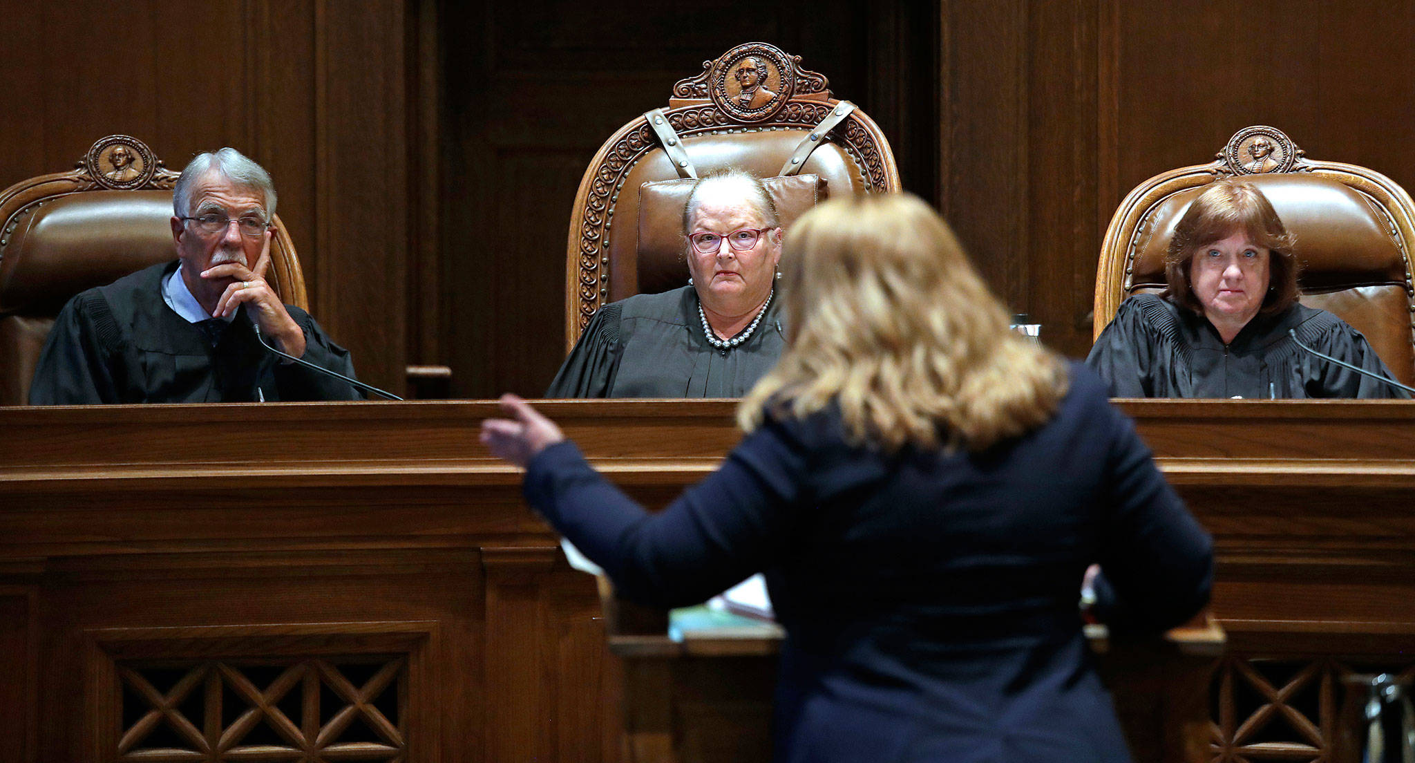 Justice Charles Johnson, Chief Justice Mary Fairhurst (center) and Justice Barbara Madsen, listen as Michele Earl-Hubbard, an attorney for a media coalition led by The Associated Press, speaks during a hearing before the Washington Supreme Court, on June 11, in Olympia, regarding whether state lawmakers are subject to the same disclosure rules that apply to other elected officials under the voter-approved Public Records Act. The court ruled Thursday that the Public Records Act does fully apply to state lawmakers, in a 7-2 decision. (Elaine Thompson / Associated Press file photo)