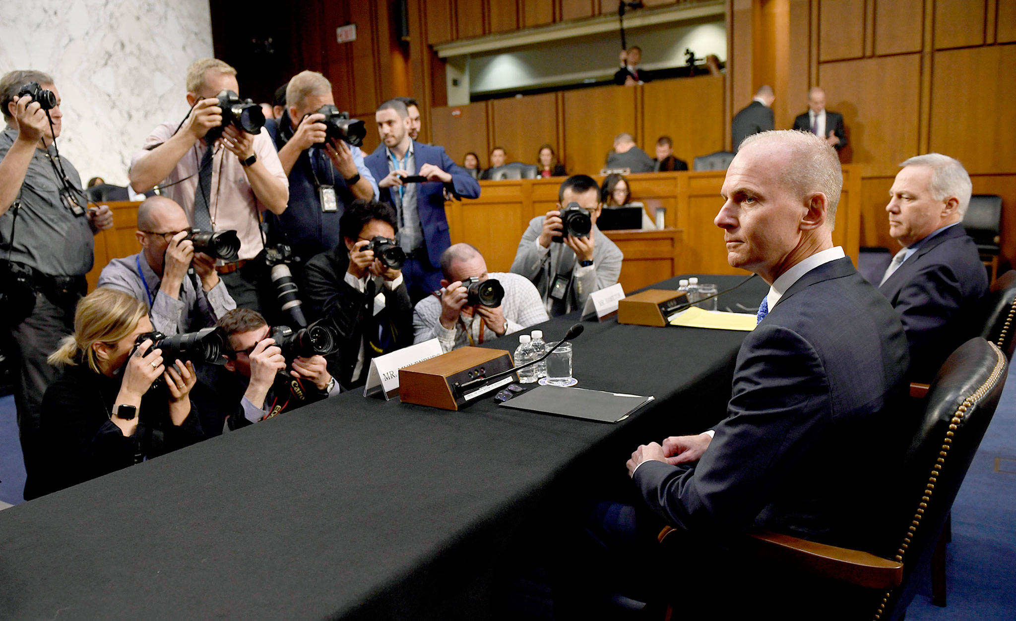 Boeing Co. President and CEO Dennis Muilenburg (second from right) is surrounded by photographers on Capitol Hill in Washington on Oct. 29. (AP Photo/Susan Walsh, File)