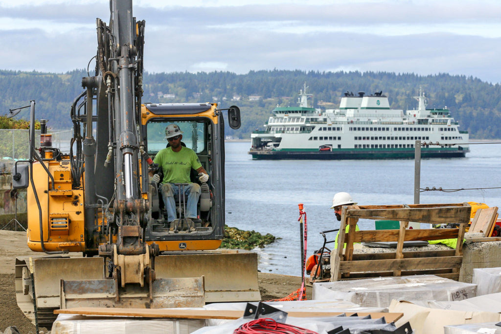 A construction worker in heavy equipment Sept. 11 excavates on the site of the new Mukilteo Ferry Terminal, which is set to open in late October 2020. (Kevin Clark / The Herald)
