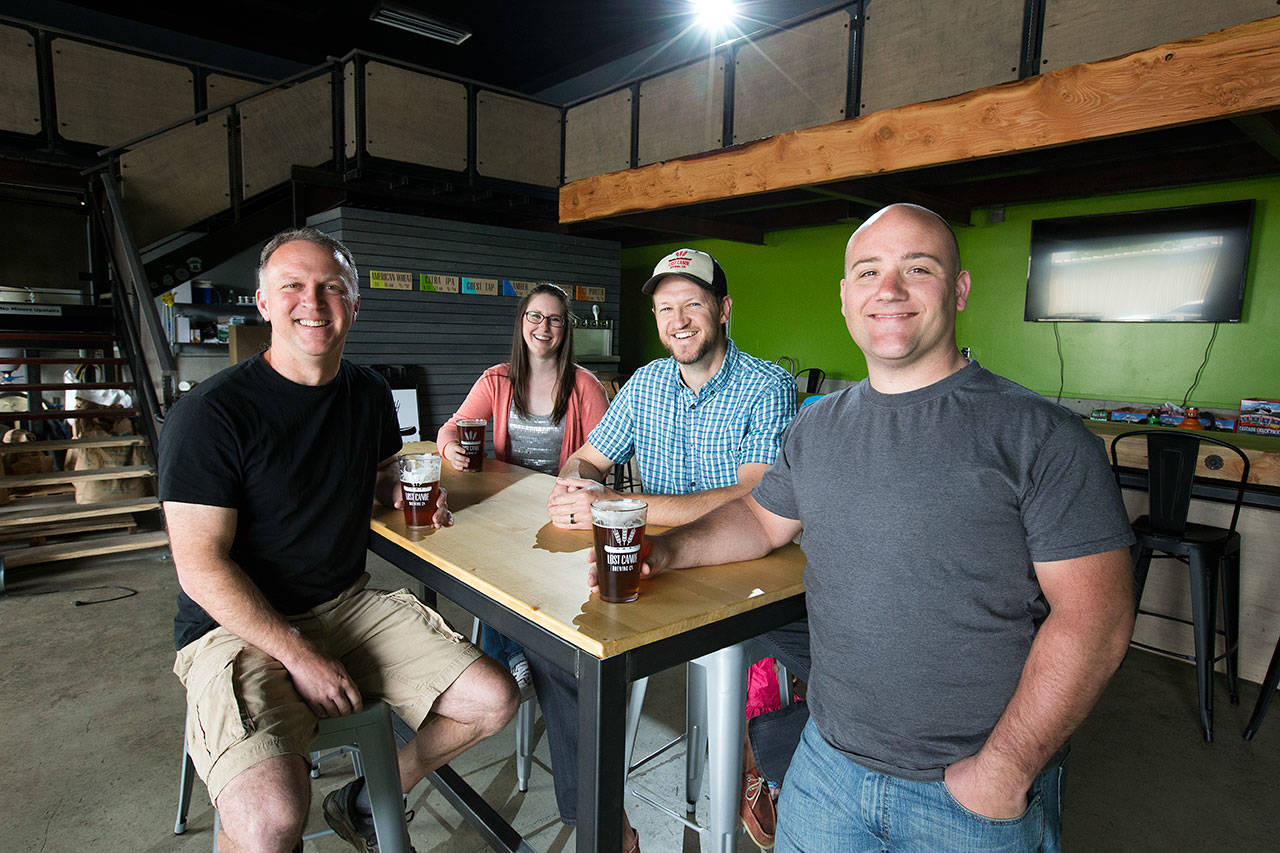 Lost Canoe owners (from left) Adam Hayes, Emily Langkow, Will Hezlep and John Carruthers closed the brewery in November. They are now focused solely on running Sound to Summit, a neighboring brewery they purchased about a year ago. (Andy Bronson /Herald file)