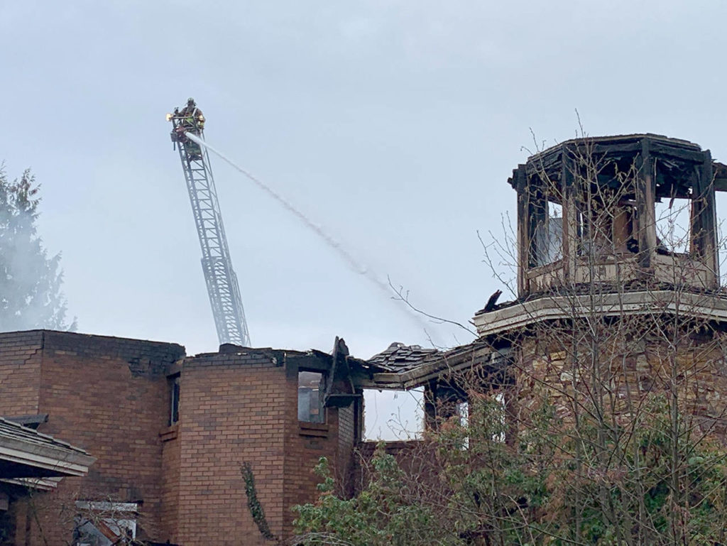 Crews were still working Thursday on the fire that collapsed a vacant 14,000-square-foot house on Fisher Road in Edmonds. (South County Fire)
