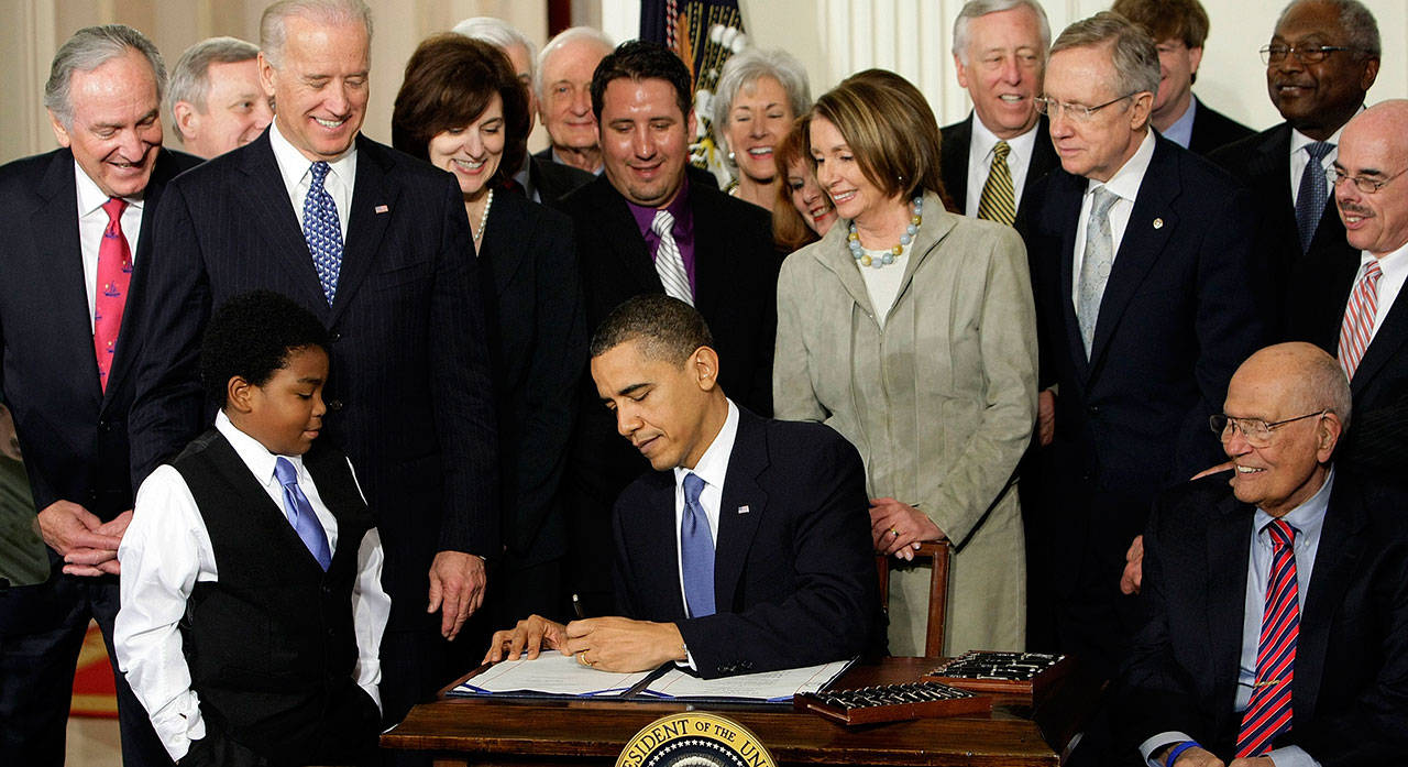 President Barack Obama signs the Patient Protection and Affordable Care Act on March 23, 2010, in the East Room of the White House in Washington, D.C. A federal appeals court this month ruled the law’s individual mandate requiring people to buy health insurance is unconstitutional, but sent the case back to a lower court to determine the ruling’s effect on the entirety of the ACA. (J. Scott Applewhite / Associated Press file photo)