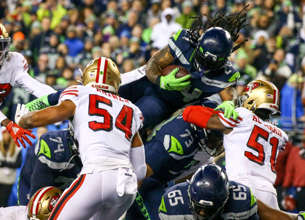 Seattle Seahawks’ Marshawn Lynch leaps the line for a touchdown against the 49ers Sunday evening at CenturyLink Field in Seattle on December 29, 2019. The 49ers won 26-21. (Kevin Clark / The Herald)
