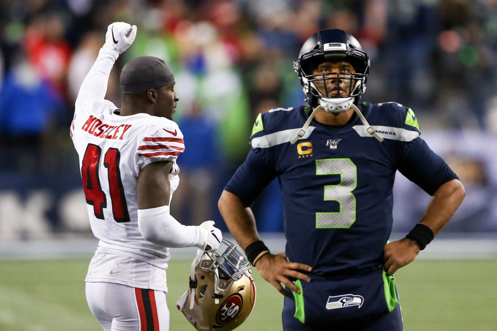Seattle Seahawks’ Russell Wilson watches the replay as San Francisco’s Emmanuel Moseley celebrates the 49ers win, 26-21, Sunday evening at CenturyLink Field in Seattle on December 29, 2019. (Kevin Clark / The Herald)
