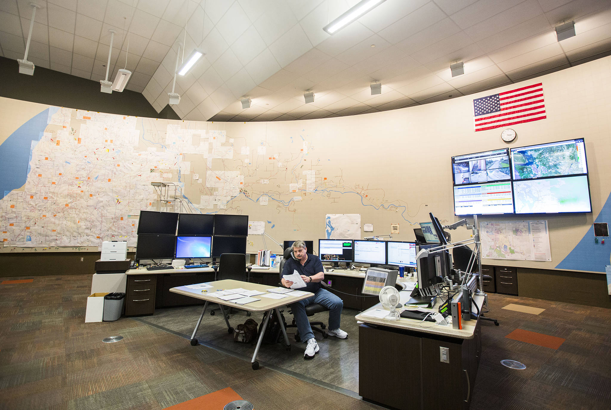 A systems operator works at a desk at the the energy control center at Snohomish County PUD Operations Center. It requires a special clearance to get into this room that monitors maps of the electrical system grid. (Olivia Vanni / Herald file)