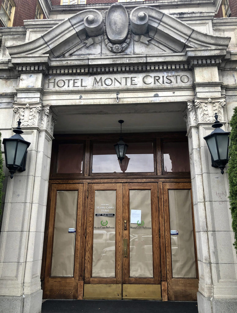 A printed note on letterhead taped on the front door informs the Monte Cristo Ballroom in downtown Everett is closed on Oct. 15. “We regret to inform you that as of today, we will no longer be doing business … This includes all weddings we have scheduled now through 2021,” it reads. (Andrea Brown / The Herald)
