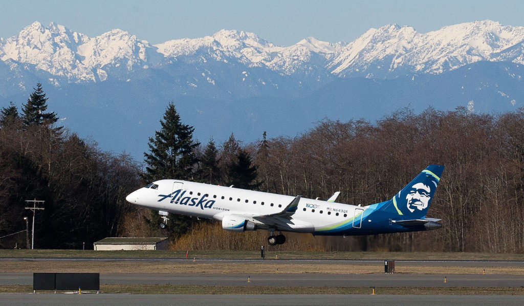 With the Olympic mountains in the background, the first passenger flight by Alaska Airlines Flight 2878 departs for Portland on opening day of the Paine Field Terminal on March 4 in Everett. (Andy Bronson / The Herald)
