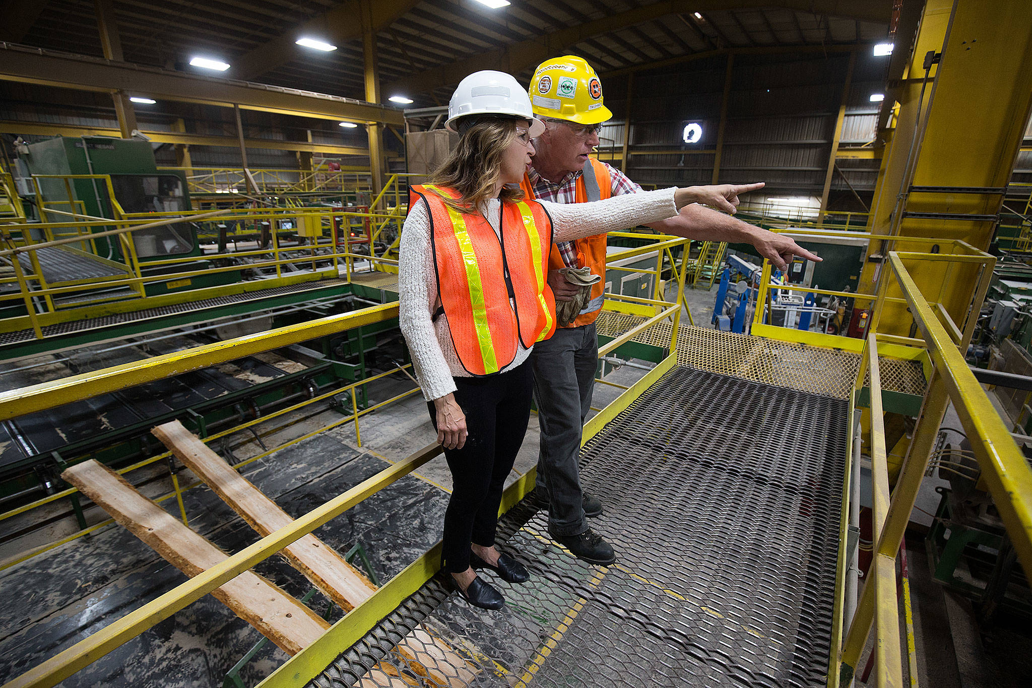 Commissioner of Public Lands Hilary Franz and Hampton Mill manager Tim Johnson talk over the noise of the mill during a tour on Thursday, Aug. 29, 2019 in Darrington, Wash. (Andy Bronson / The Herald)