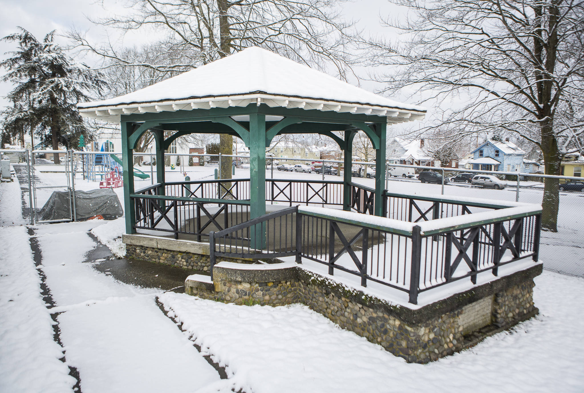 The gazebo at Clark Park sits covered in snow Jan. 14, in Everett. After decades behind a fence, the city is considering removing the barrier. (Olivia Vanni / The Herald)