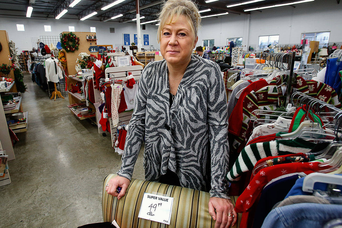At the St. Vincent de Paul Thrift Store in Everett, Inga Paige shows a wide range of merchandise, bargain furniture to clothing and holiday decor. The store sees an increase in donations of used goods after the holidays. (Dan Bates / The Herald)