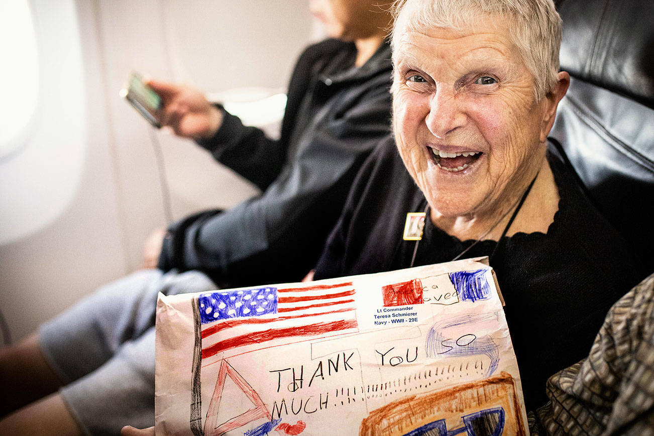 Teresa Schmierer, a 100-year-old Navy nursing veteran, aboard a plane during her trip last September with Puget Sound Honor Flight. The nonprofit group provides free trips to Washington, D.C., to see the nation’s memorials. (Puget Sound Honor Flight)