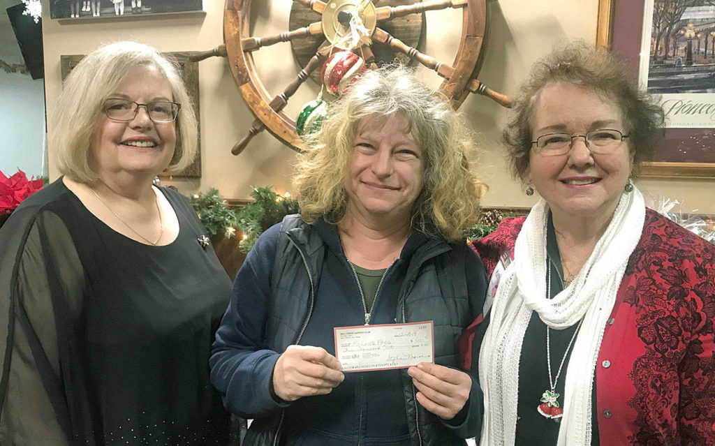 Zsofia Pasztor (center) receives a check from Mill Creek Garden Club President Lyndal Kennedy (left) and the club’s grants chairwoman, Kathi Zehner. (Mill Creek Garden Club) 
