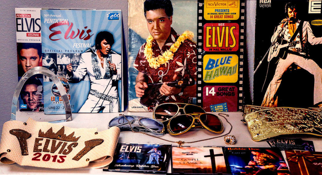 Rob Schwertley, who performs as Elvis tribute artist Robby Dee, has Presley albums and other mementos in his Everett home. Lower left is the belt he won at the 2015 Seattle Elvis Invitationals. (Dan Bates / The Herald)
