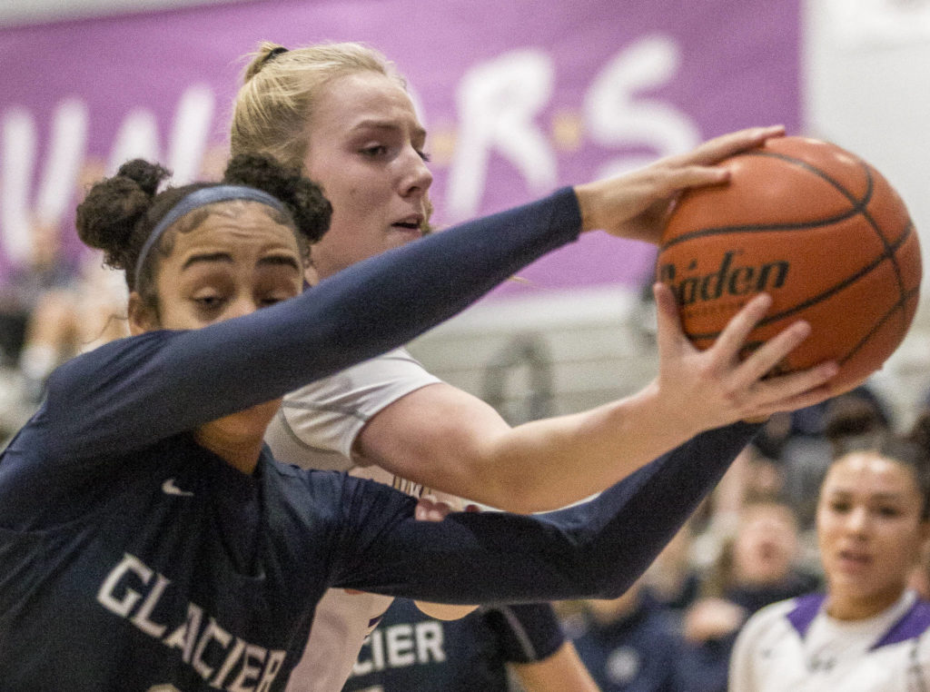 Lake Stevens’ Chloe Pattison fights for the ball with Glacier Peak’s Aaliyah Collins during the game at Lake Stevens High School on Saturday, Jan. 4, 2020 in Lake Stevens, Wash. (Olivia Vanni / The Herald).
