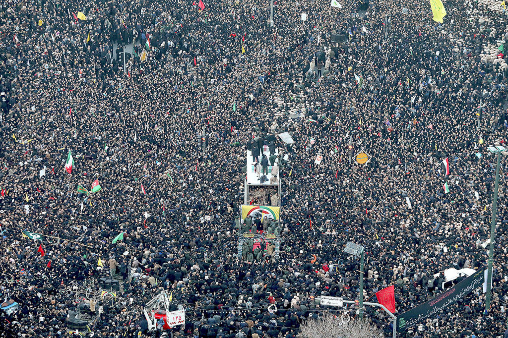 Coffins of Gen. Qassem Soleimani and others who were killed in Iraq by a U.S. drone strike, are carried on a truck surrounded by mourners Sunday during a funeral procession, in the city of Mashhad, Iran. Soleimani’s death Friday in Iraq further heightens tensions between Tehran and Washington after months of trading attacks and threats that put the wider Middle East on edge. (Mohammad Hossein Thaghi/Tasnim News Agency via AP)

