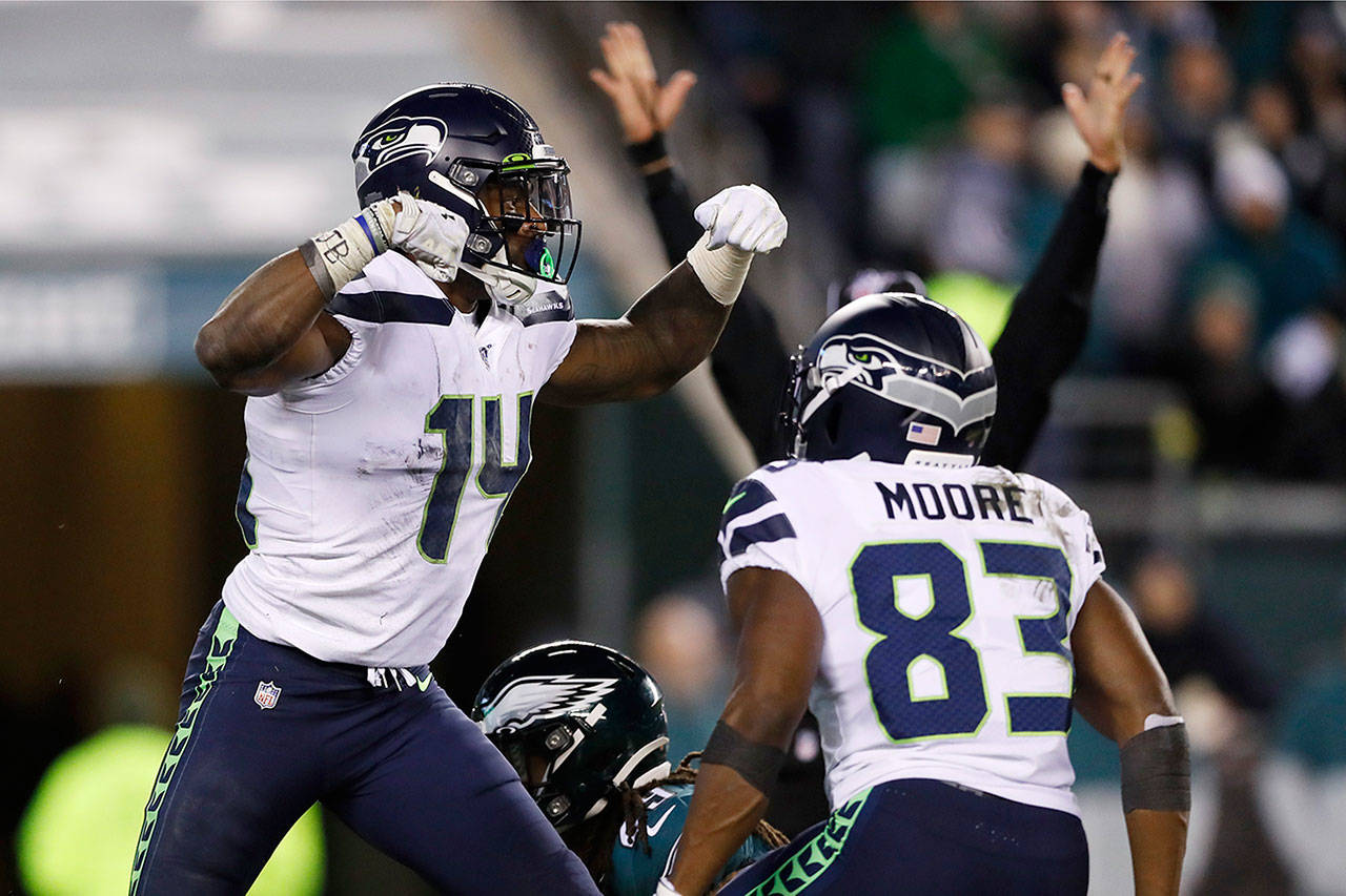 Seattle wide receivers D.K. Metcalf (14) and David Moore celebrate after Metcalf’s touchdown catch in the second half of Sunday’s NFC wild-card playoff game against the Philadelphia Eagles. (AP Photo/Julio Cortez)