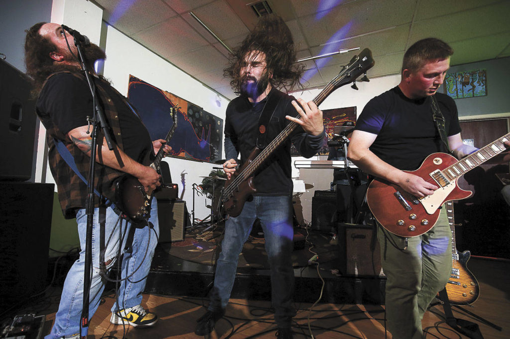 Members of The Moon Is Flat, a Lake Stevens band, perform at Black Lab Gallery. (Andy Bronson / The Herald)

