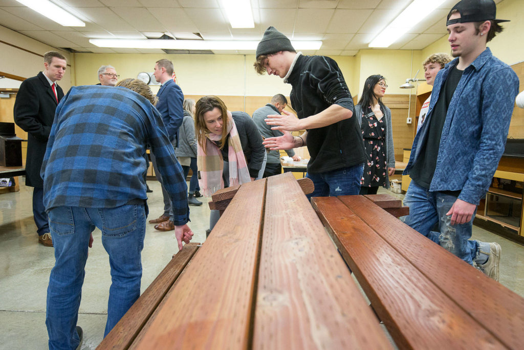 Ashton Beigler, a student in the Regional Apprenticeship Pathways Program, explains on Tuesday how the class built a picnic table that folds into two benches. The new program is open to students countywide, and is housed at Marysville Pilchuck High School. (Andy Bronson / The Herald)
