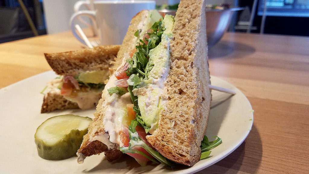 The Jetty sandwich has smoked salmon cream cheese, cucumbers, avocado, tomato, pickled red onion and arugula on toasted whole wheat bread. (Sharon Salyer / The Herald)
