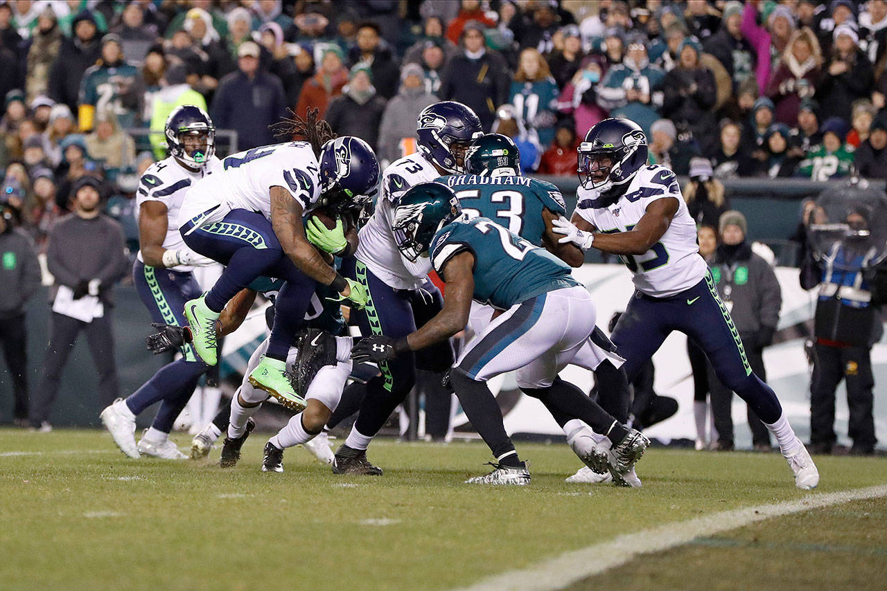 Seattle’s Marshawn Lynch (24) bulls past Philadelphia’s Malcolm Jenkins (27) for a touchdown during the Seahawks’ 19-7 win over the Eagles in Sunday’s wild-card playoff game in Philadelphia. (AP Photo/Julio Cortez)