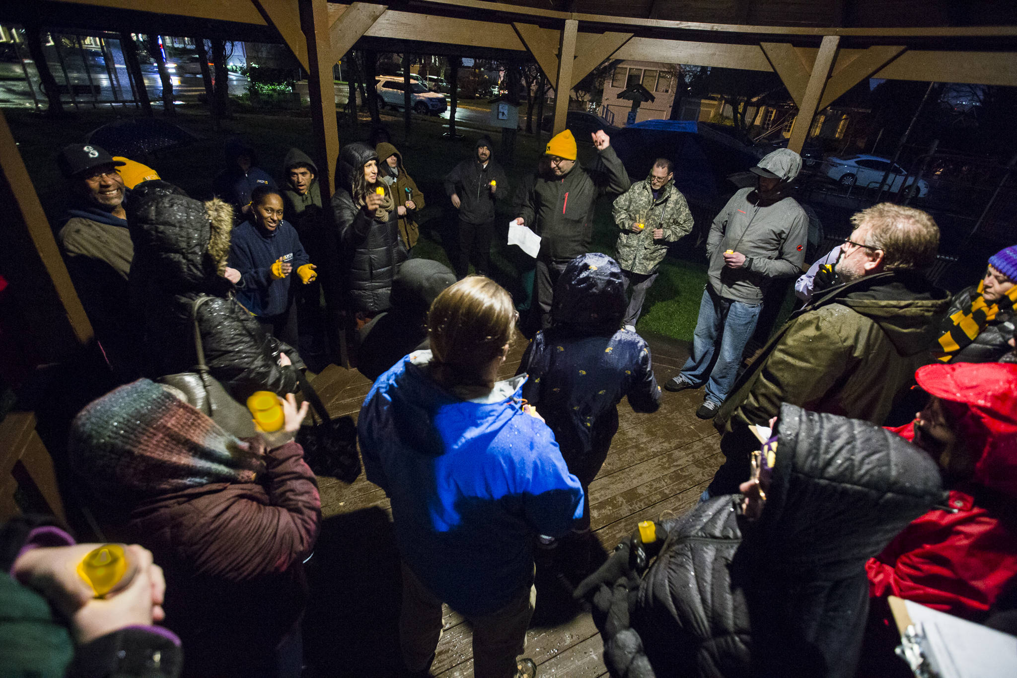 UFCW 21 representative Anthony Cantu (center) pumps his fist in the air as others clap in response to the news that a tentative agreement had been reached with Providence during a union contract negotiation vigil at Northwest Everett Neighborhood Park across from Providence Region Medical Center Everett on Wednesday in Everett. (Olivia Vanni / The Herald).