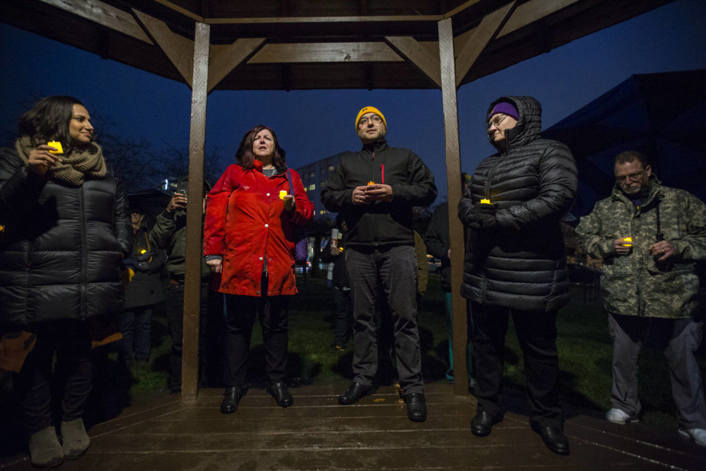 UFCW 21 representatives Cathy Macphail (left), Anthony Cantu (center) and Home Health and Hospice worker Debi Schmidt (right) talk during a union contract negotiation vigil at Northwest Everett Neighborhood Park on Wednesday. (Olivia Vanni / The Herald).
