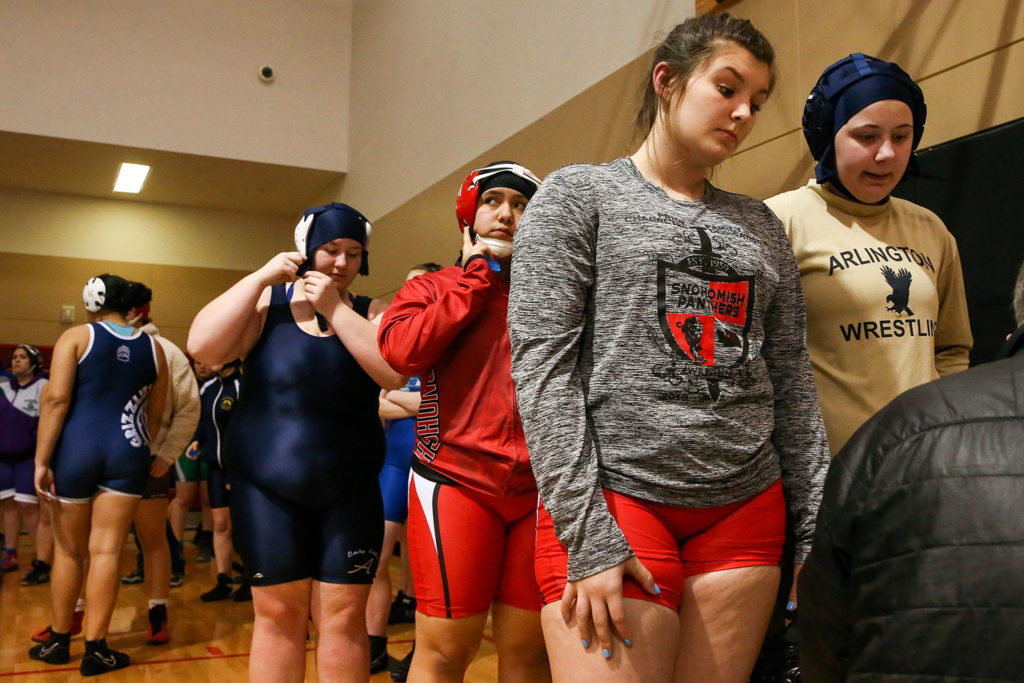 Participants wait to sign up for matches prior to last week’s girls wrestling scramble at Snohomish High School. (Kevin Clark / The Herald)
